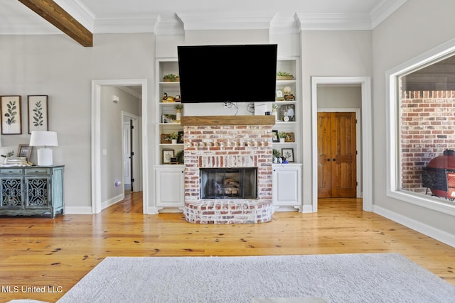 unfurnished living room featuring baseboards, ornamental molding, wood finished floors, a fireplace, and beam ceiling