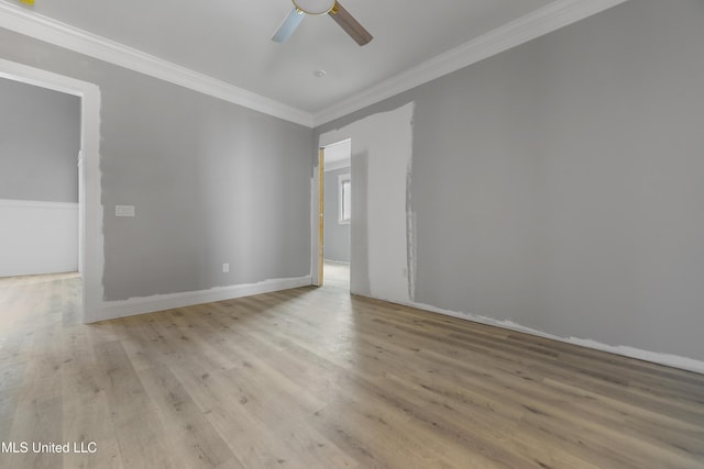 spare room with crown molding, light hardwood / wood-style floors, and ceiling fan