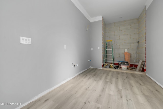 spare room with crown molding and light hardwood / wood-style floors