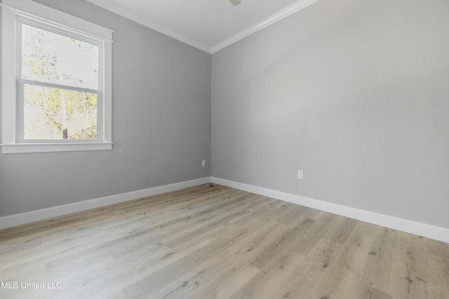 unfurnished room featuring ornamental molding and light wood-type flooring