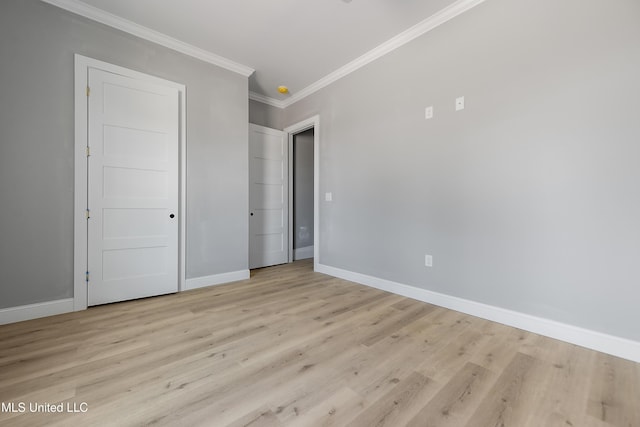 unfurnished bedroom featuring ornamental molding and light hardwood / wood-style floors