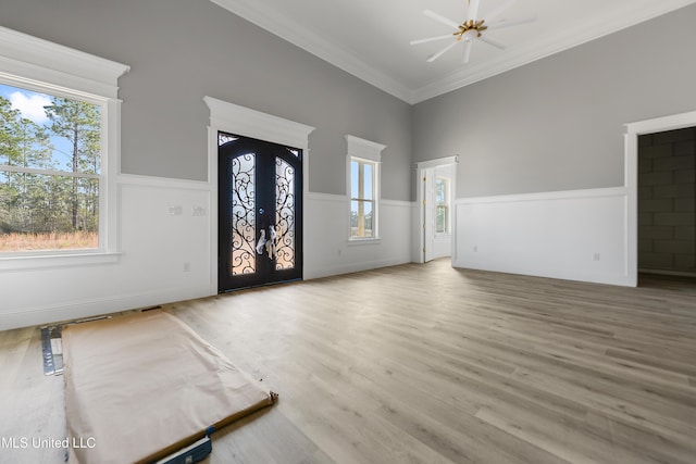 entryway featuring crown molding, wood-type flooring, and french doors