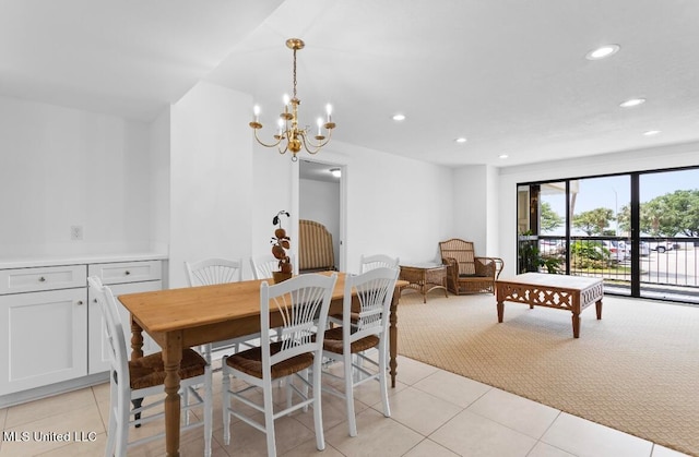 dining area with a chandelier and light carpet