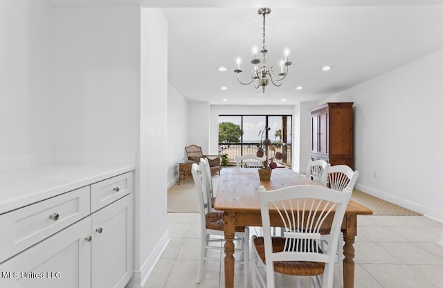 dining space with light carpet and an inviting chandelier