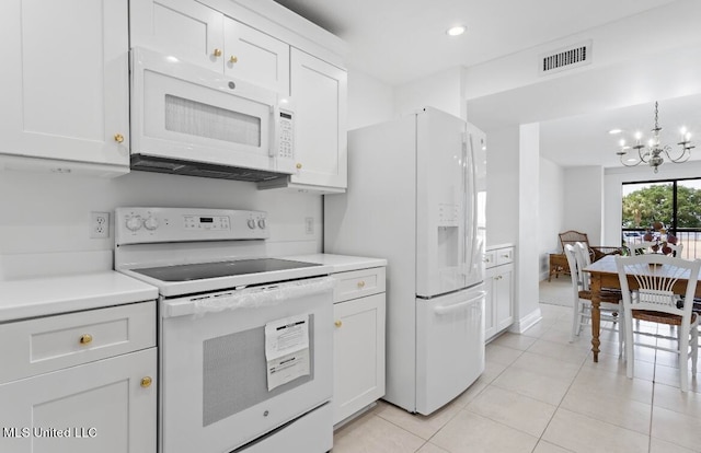 kitchen with a chandelier, white cabinets, white appliances, and light tile patterned floors