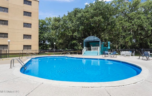 view of swimming pool featuring a patio area