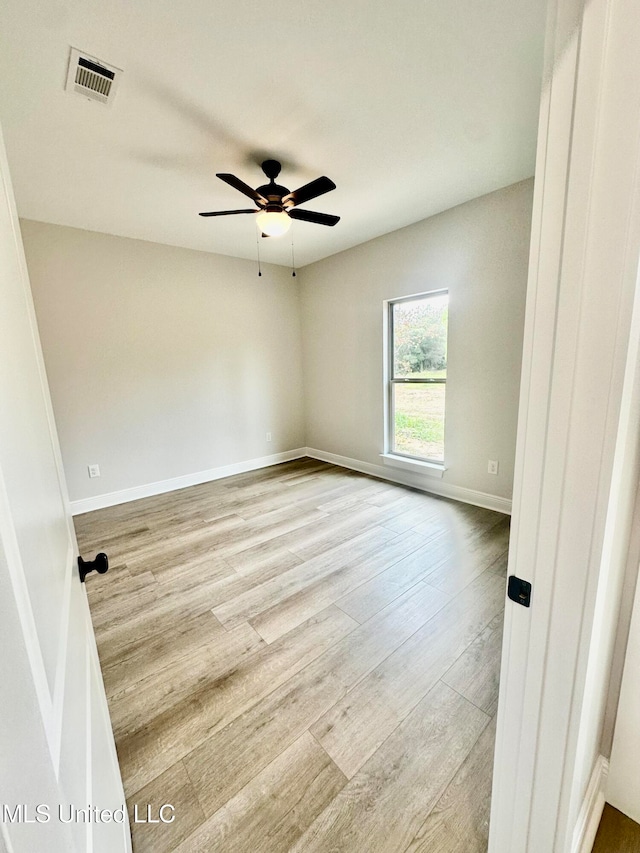 spare room featuring light hardwood / wood-style floors and ceiling fan