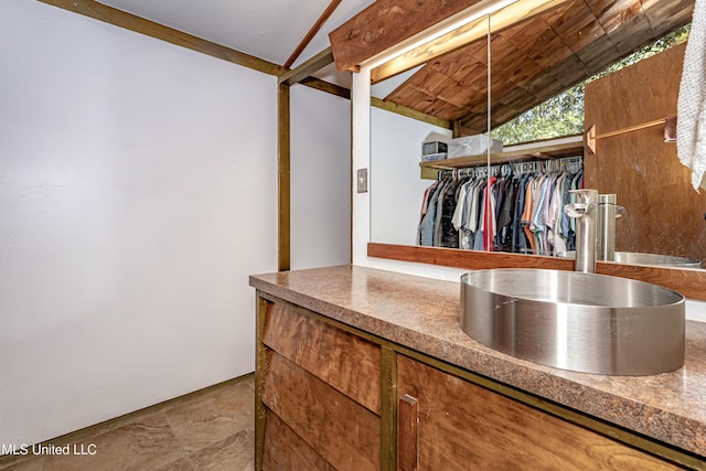 spacious closet with vaulted ceiling and a sink
