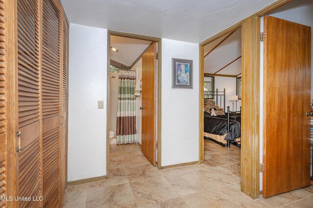 corridor featuring baseboards