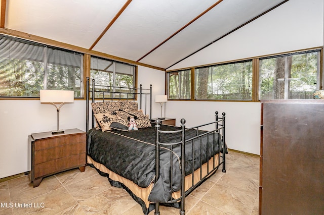 bedroom with vaulted ceiling and baseboards