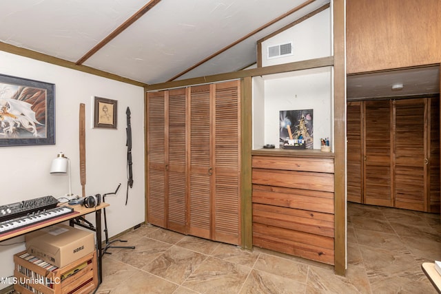 interior space featuring lofted ceiling and visible vents