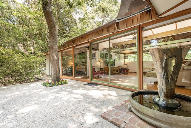 view of patio featuring a sunroom