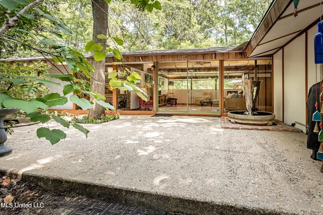 view of patio / terrace featuring a sunroom