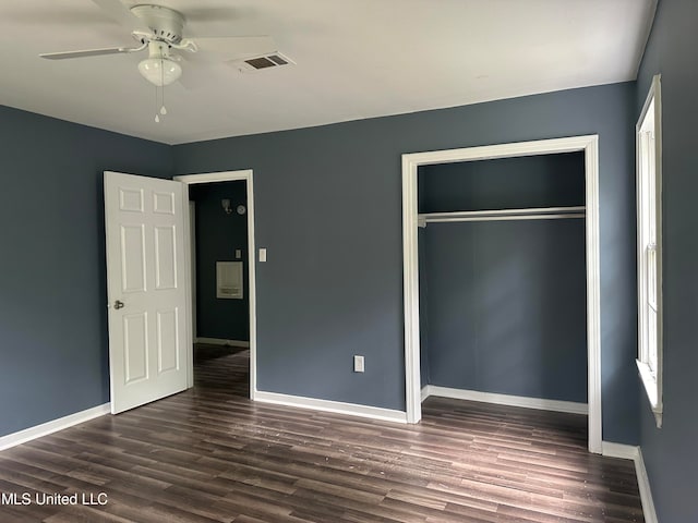 unfurnished bedroom featuring dark hardwood / wood-style floors, a closet, and ceiling fan