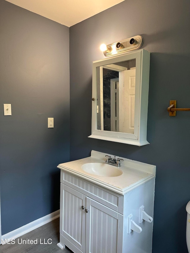 bathroom featuring vanity and toilet