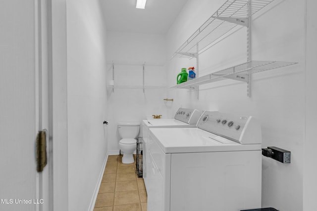 clothes washing area featuring separate washer and dryer and light tile patterned flooring