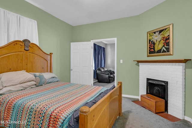 bedroom with light carpet and a brick fireplace