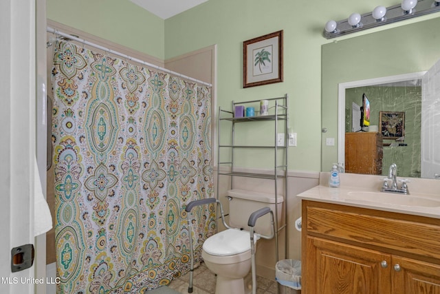 bathroom featuring walk in shower, vanity, tile patterned floors, and toilet