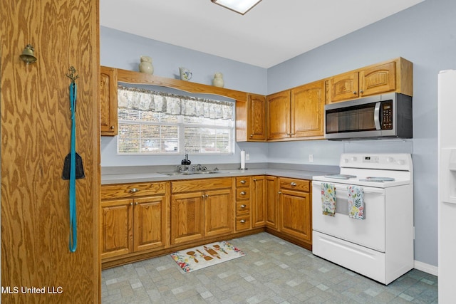 kitchen featuring white electric stove and sink