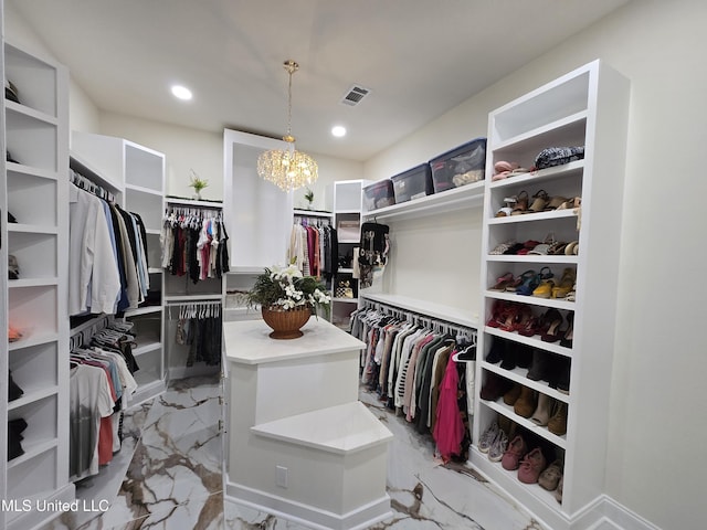 spacious closet with marble finish floor, a notable chandelier, and visible vents