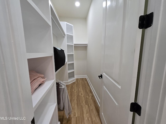 spacious closet with wood finished floors