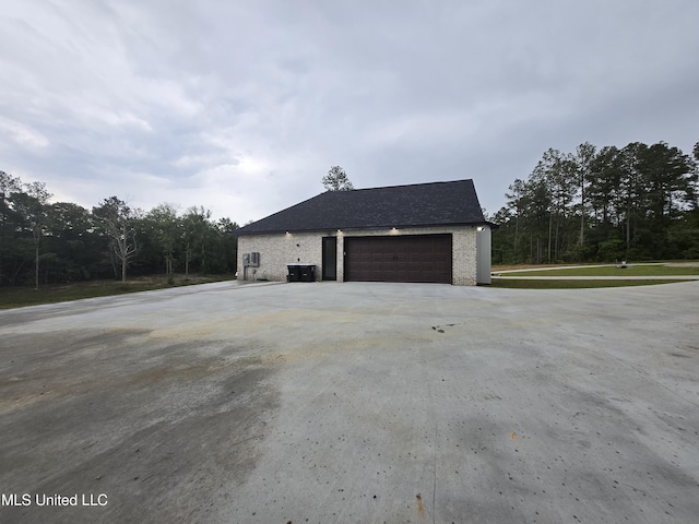 view of home's exterior with central air condition unit and driveway