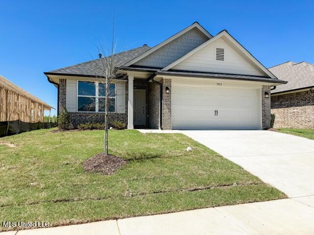 7859 Gardendale Dr, Olive Branch, MS 38654 - view of front of property featuring a garage, brick siding, concrete driveway, and a front yard