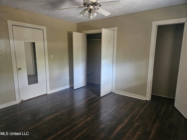 unfurnished bedroom featuring dark wood finished floors, baseboards, and ceiling fan