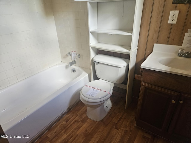 full bath with toilet, wood finished floors, and vanity