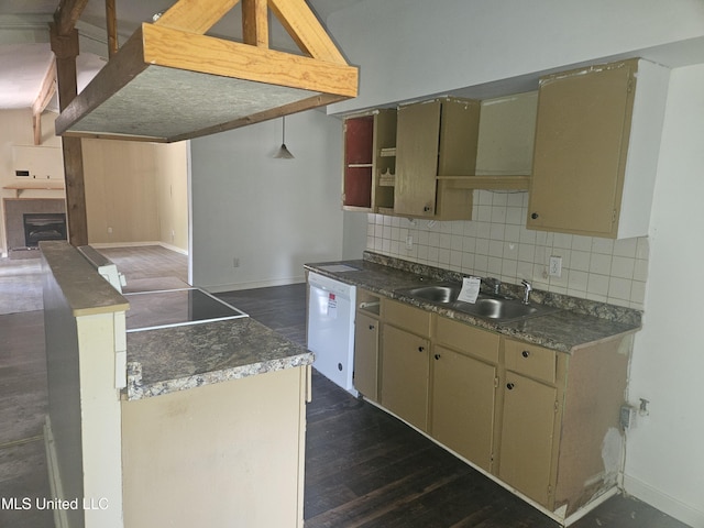 kitchen featuring a sink, white dishwasher, decorative backsplash, and baseboards