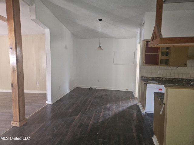 unfurnished dining area featuring dark wood finished floors and baseboards