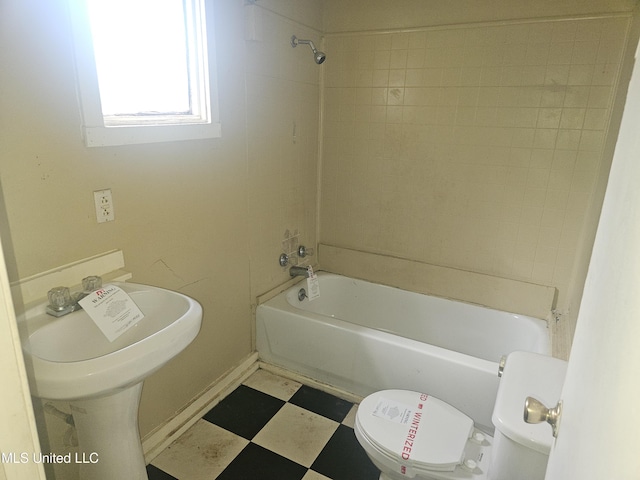 full bathroom featuring tile patterned floors, toilet, washtub / shower combination, and a sink