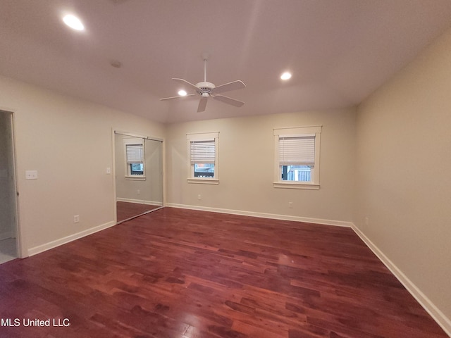 empty room with dark hardwood / wood-style floors and ceiling fan