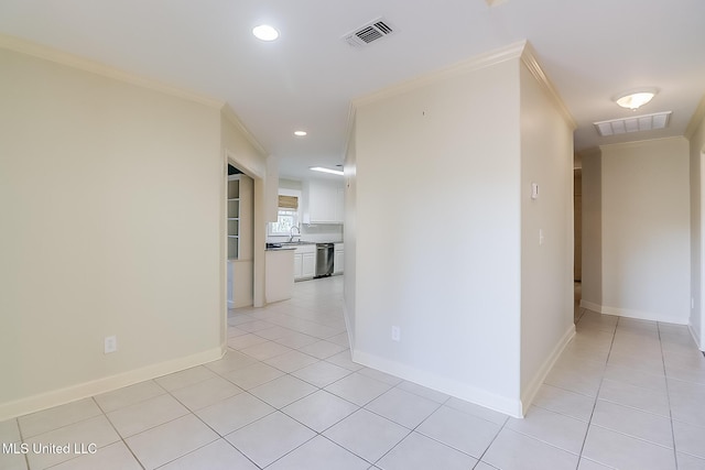 hall with crown molding and light tile patterned floors