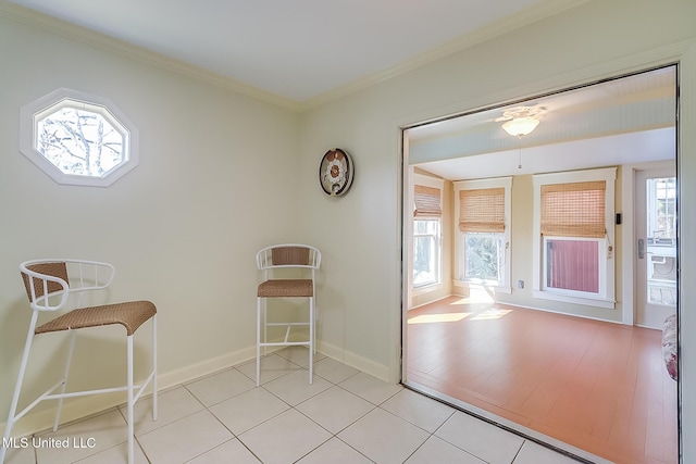 interior space featuring ornamental molding and light tile patterned floors