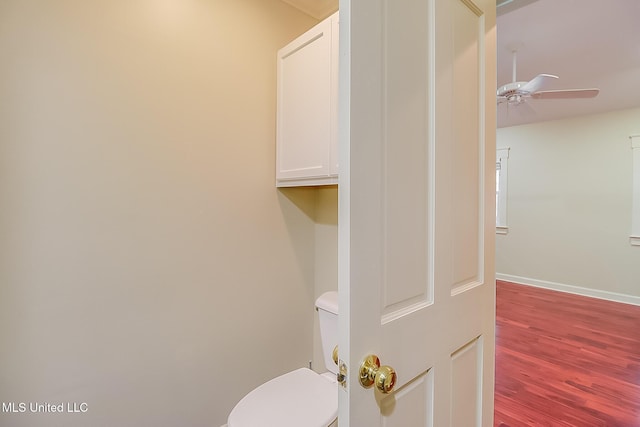 bathroom featuring ceiling fan, hardwood / wood-style floors, and toilet