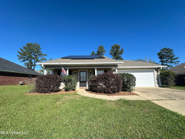 view of front of home with solar panels, a porch, a garage, and a front lawn