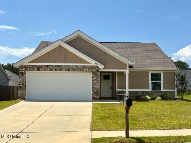 14840 Audubon Lake Blvd, Gulfport, MS 39503 - craftsman inspired home featuring brick siding, an attached garage, concrete driveway, and roof with shingles