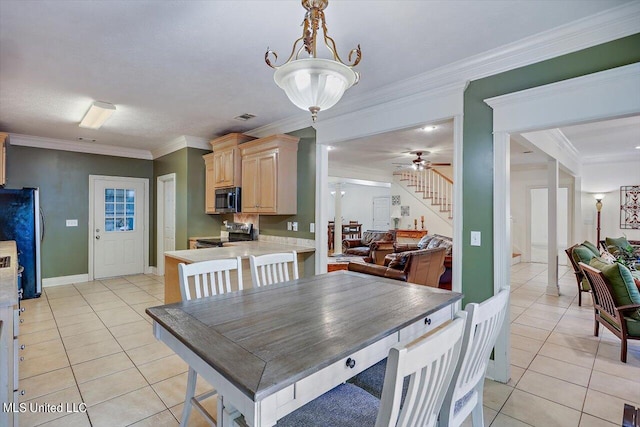 dining area with ornamental molding, light tile patterned flooring, and ceiling fan