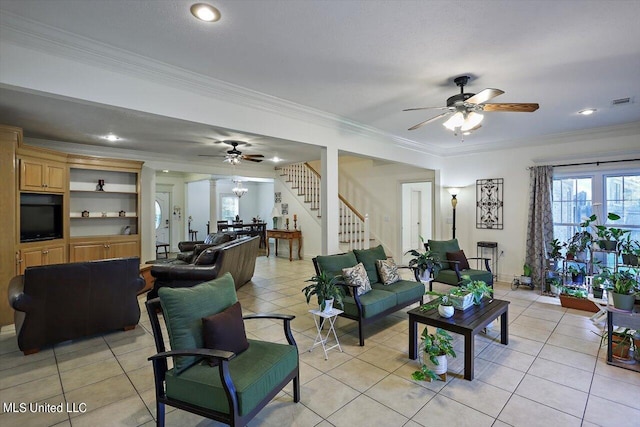 living room with crown molding, ceiling fan, and light tile patterned floors