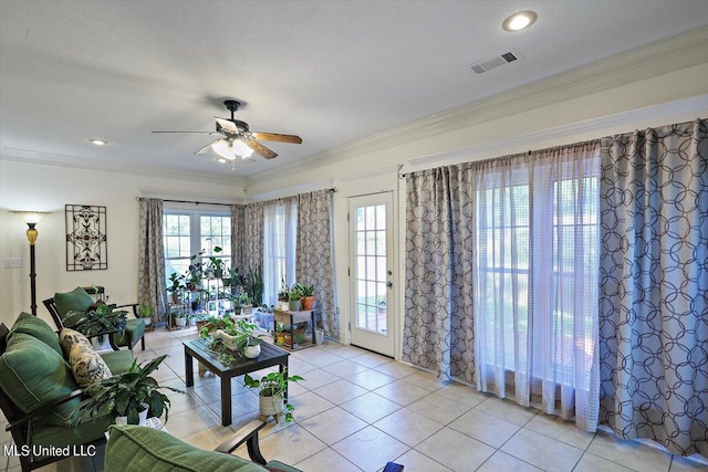 living room featuring ceiling fan, ornamental molding, and light tile patterned floors