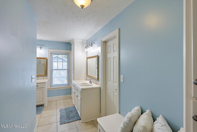 bathroom featuring vanity, a textured ceiling, and tile patterned flooring