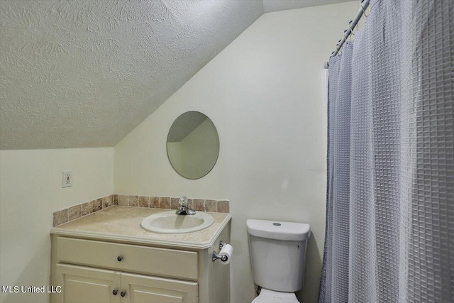 bathroom featuring lofted ceiling, a textured ceiling, toilet, vanity, and curtained shower