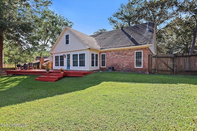 back of house featuring a wooden deck and a yard