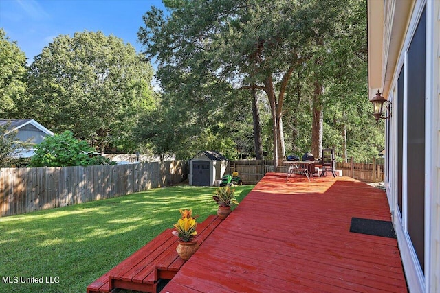 wooden deck with a shed and a lawn