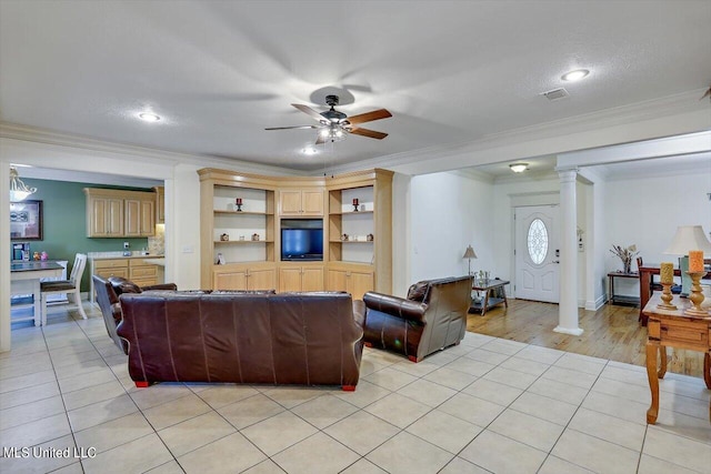 living room featuring crown molding, ornate columns, light hardwood / wood-style floors, and ceiling fan