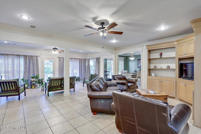 living room featuring ornamental molding, ceiling fan, a textured ceiling, and plenty of natural light