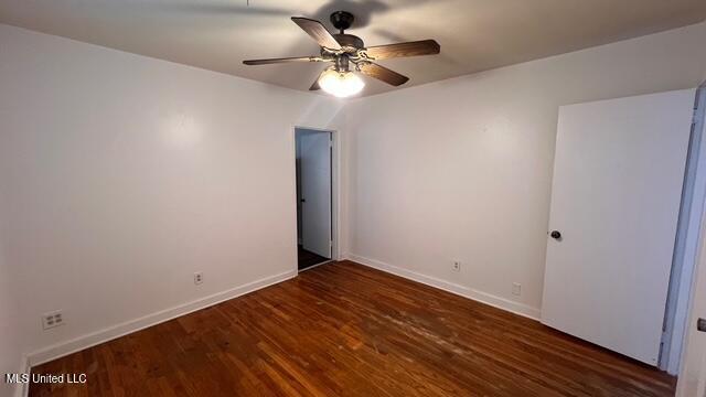 spare room with a ceiling fan, baseboards, and wood finished floors