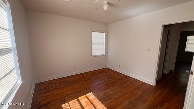 empty room with baseboards and wood finished floors