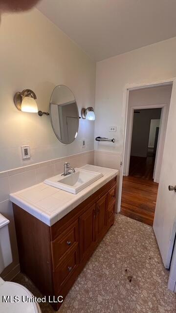 bathroom featuring wainscoting and vanity